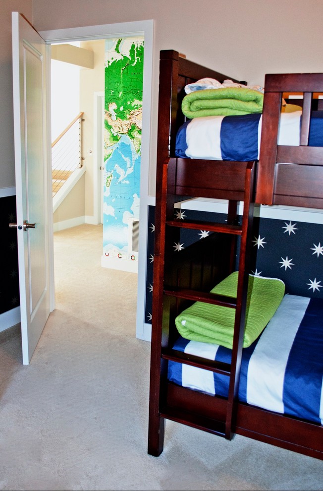 This is an example of a medium sized classic gender neutral children’s room in Seattle with blue walls and carpet.