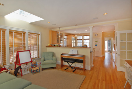 Photo of a large traditional gender neutral playroom in Boston with beige walls and light hardwood flooring.