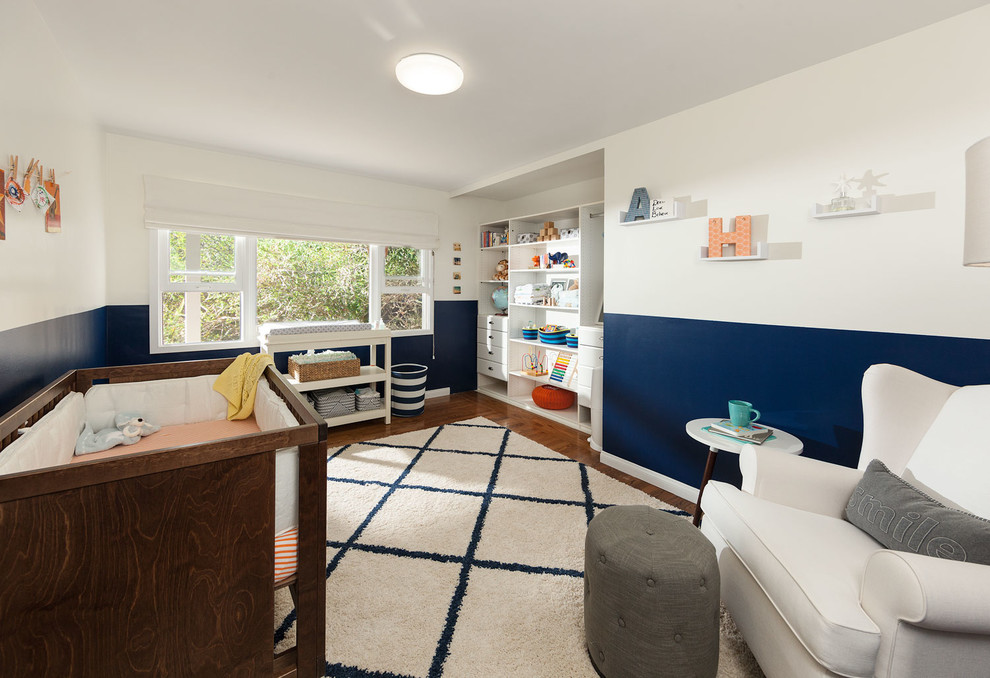 Inspiration for a mid-sized coastal boy medium tone wood floor kids' room remodel in Los Angeles with blue walls