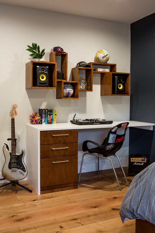 Inspiration for a medium sized contemporary teen’s room for boys in Los Angeles with light hardwood flooring, black walls and orange floors.