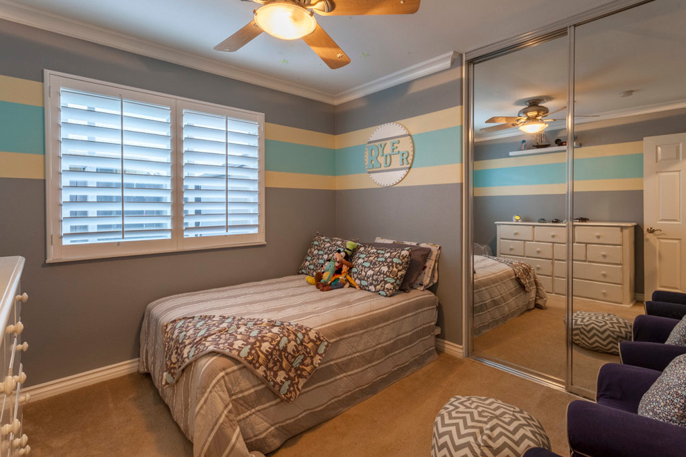 Photo of a small contemporary toddler’s room for boys in Los Angeles with grey walls and carpet.