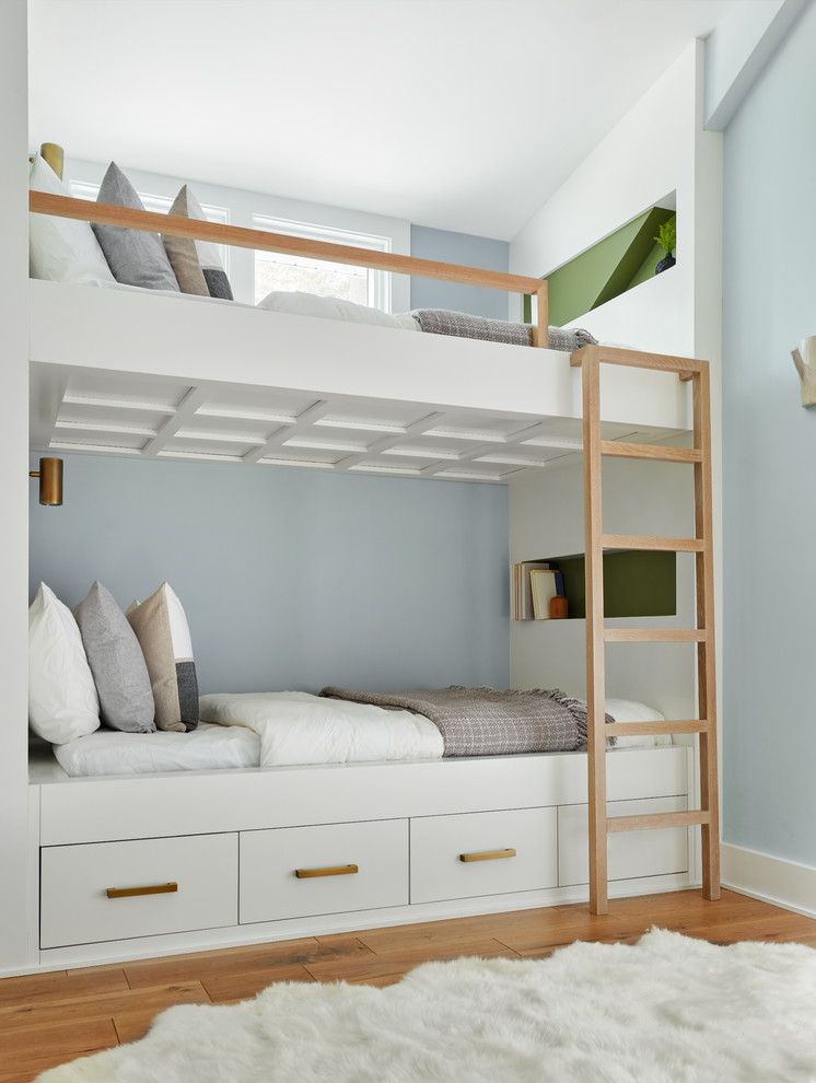 Inspiration pour une chambre d'enfant marine avec un mur bleu, un sol en bois brun, un sol marron et un lit superposé.