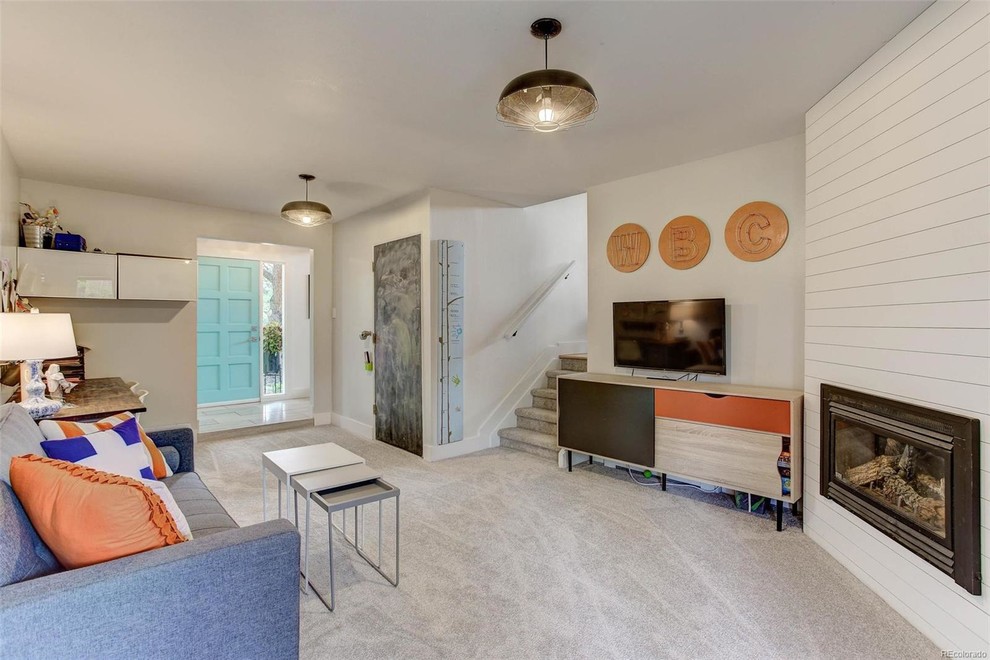 This is an example of a medium sized midcentury kids' bedroom for boys in Denver with white walls, carpet and grey floors.