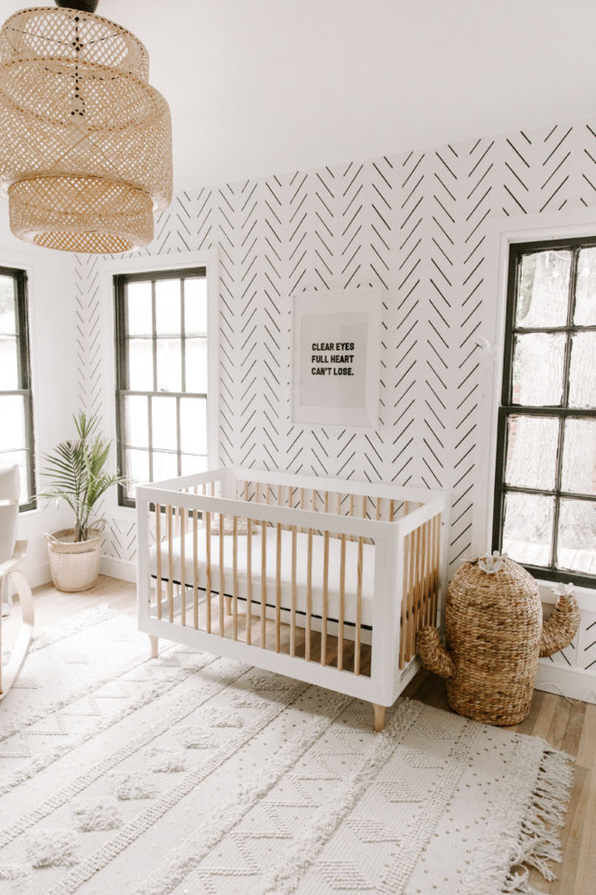 Inspiration for a medium sized scandinavian gender neutral toddler’s room in Dallas with white walls, light hardwood flooring and brown floors.