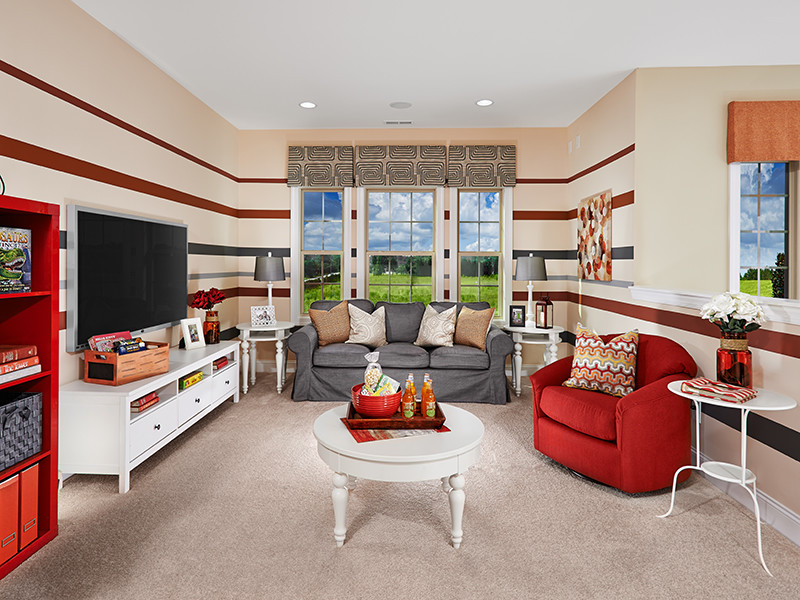 Example of a mid-sized eclectic gender-neutral carpeted kids' room design in Orlando with multicolored walls