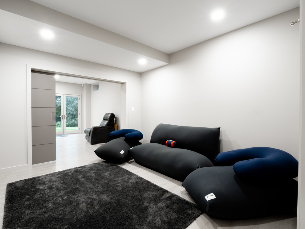 Inspiration for a mid-sized contemporary gender-neutral laminate floor and gray floor playroom remodel in Other with white walls