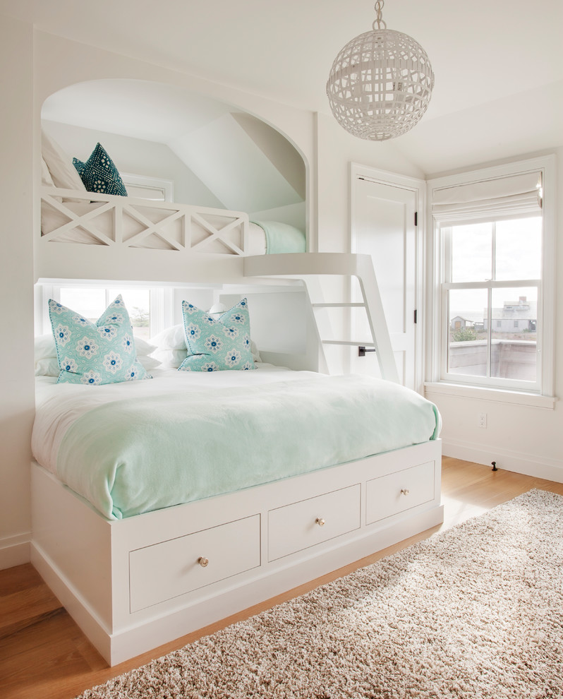 Kids' room - coastal girl light wood floor and beige floor kids' room idea in Boston with white walls