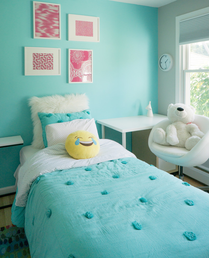 Inspiration for a small classic gender neutral children’s room in Bridgeport with multi-coloured walls and light hardwood flooring.