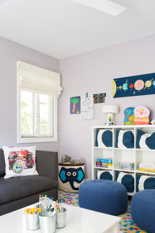 This is an example of a small contemporary gender neutral kids' bedroom in San Francisco with purple walls, medium hardwood flooring and brown floors.
