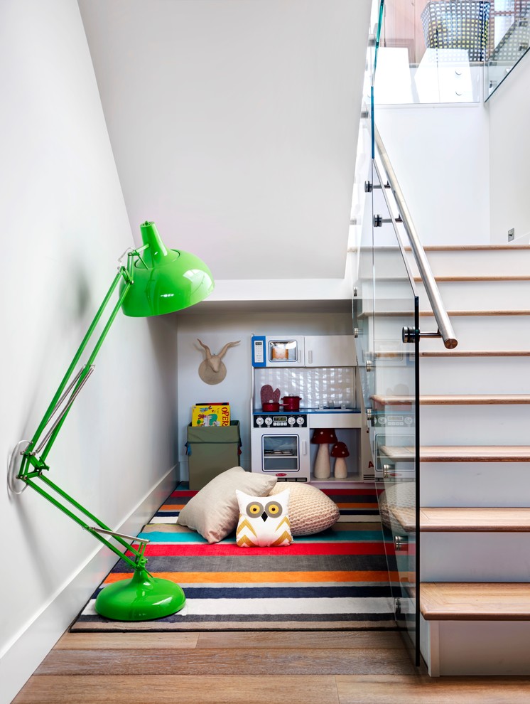 Farmhouse gender-neutral medium tone wood floor childrens' room photo in Calgary with white walls