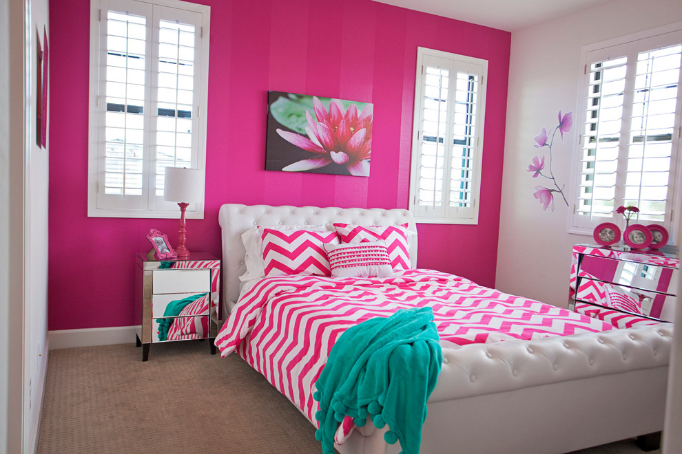Inspiration for a mid-sized modern girl carpeted kids' room remodel in Phoenix with pink walls