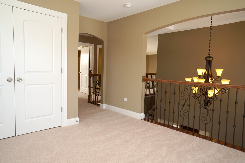 This is an example of a large traditional gender neutral kids' bedroom in Chicago with beige walls and carpet.