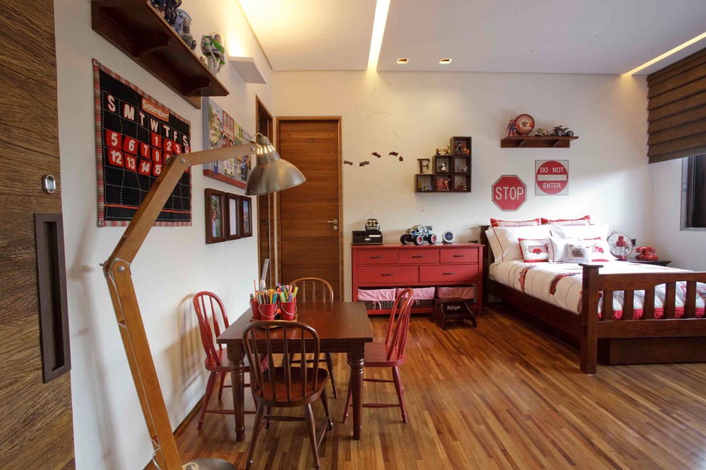 Example of an island style gender-neutral medium tone wood floor kids' room design in Other with white walls