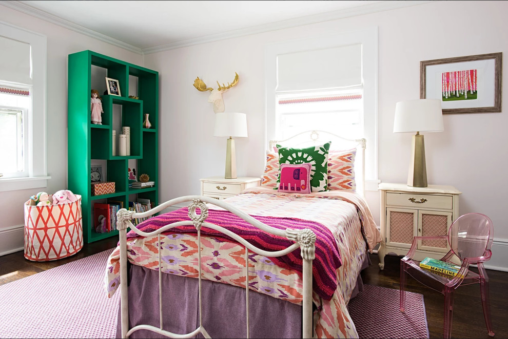 Bohemian teen’s room for girls in New York with pink walls, dark hardwood flooring and brown floors.