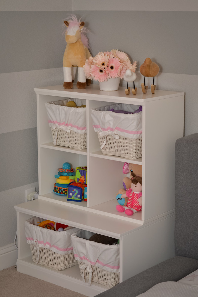 Photo of a medium sized contemporary toddler’s room for girls in Dallas with grey walls, carpet and beige floors.