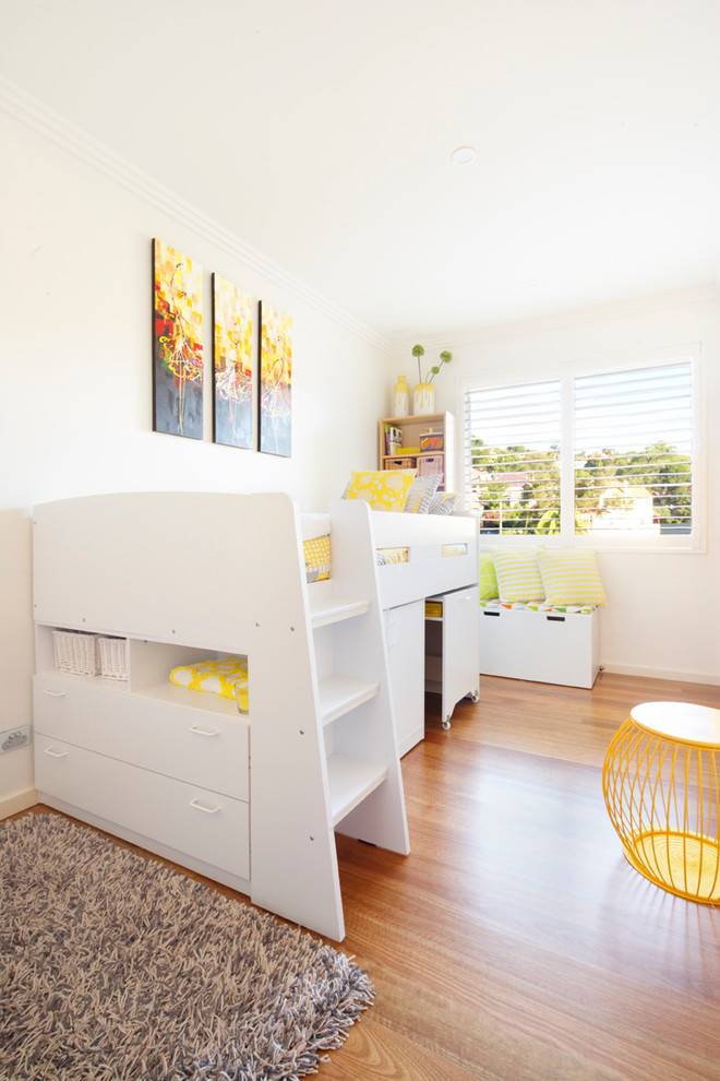 Photo of a medium sized contemporary gender neutral toddler’s room in Sydney with white walls, medium hardwood flooring and brown floors.