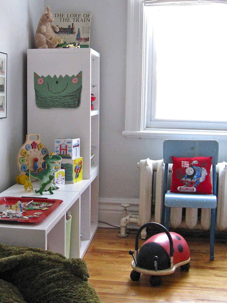 Example of an eclectic gender-neutral medium tone wood floor kids' room design in Montreal with gray walls