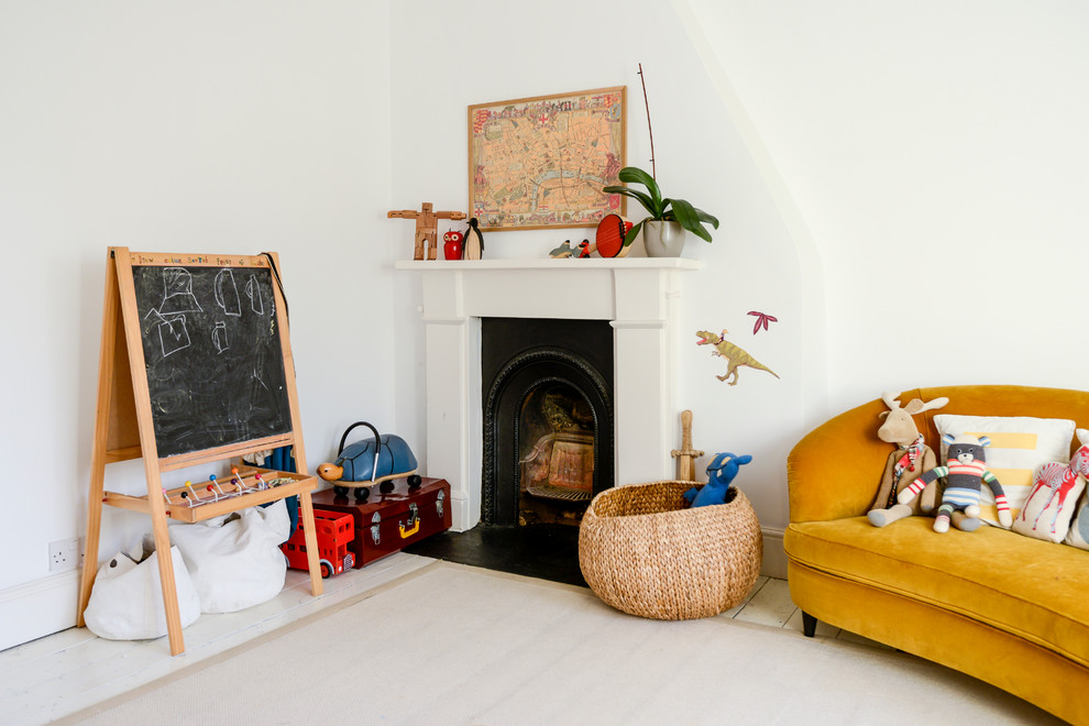 This is an example of a bohemian playroom in London with a chimney breast.