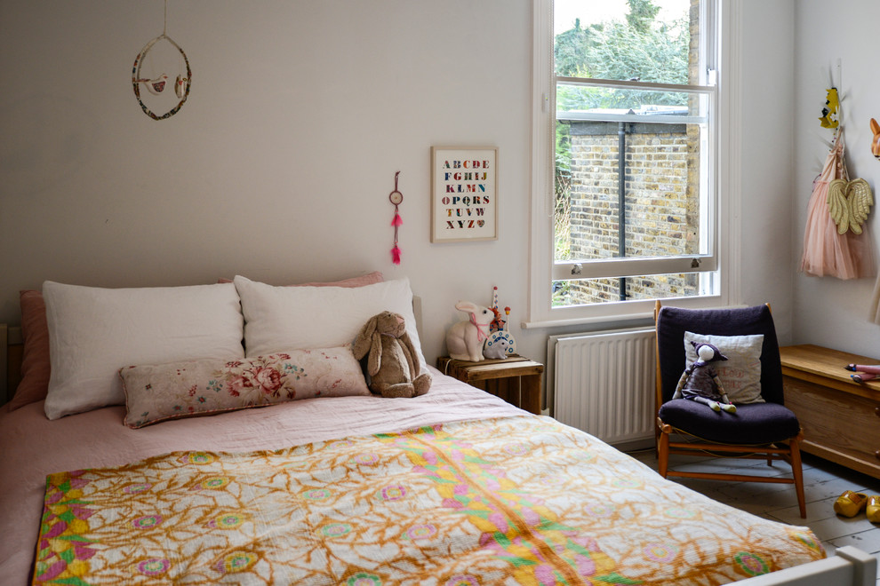 Photo of a scandi children’s room for girls in London with white walls and painted wood flooring.