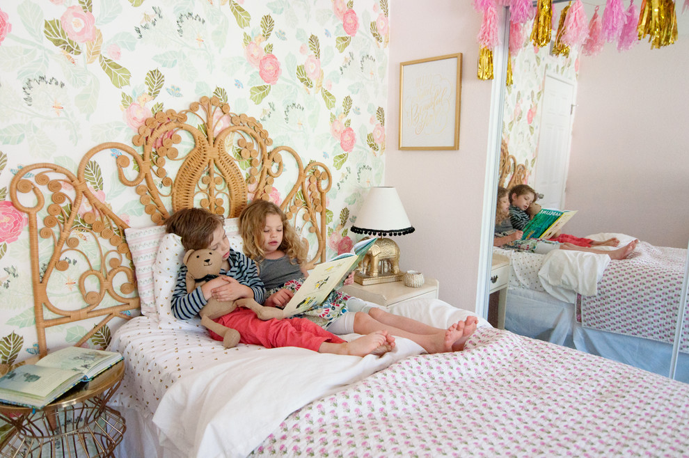 Design ideas for a medium sized bohemian children’s room for girls in Los Angeles with pink walls.