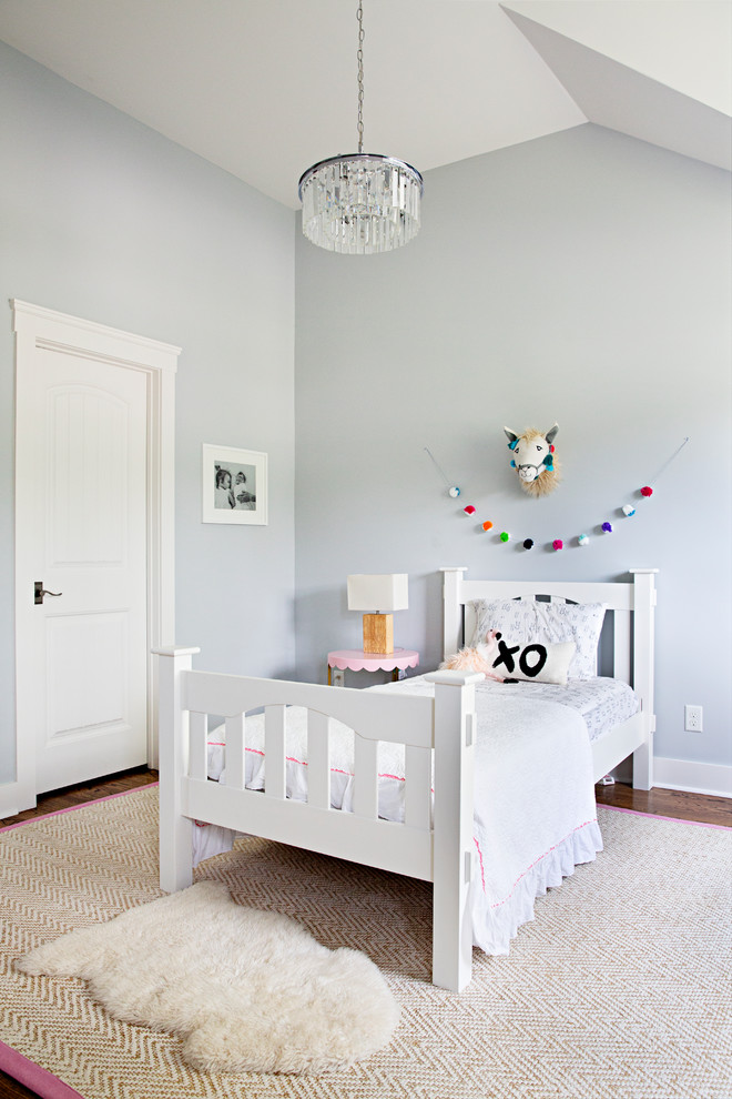 Inspiration for a farmhouse girl dark wood floor and brown floor kids' room remodel in Nashville with blue walls