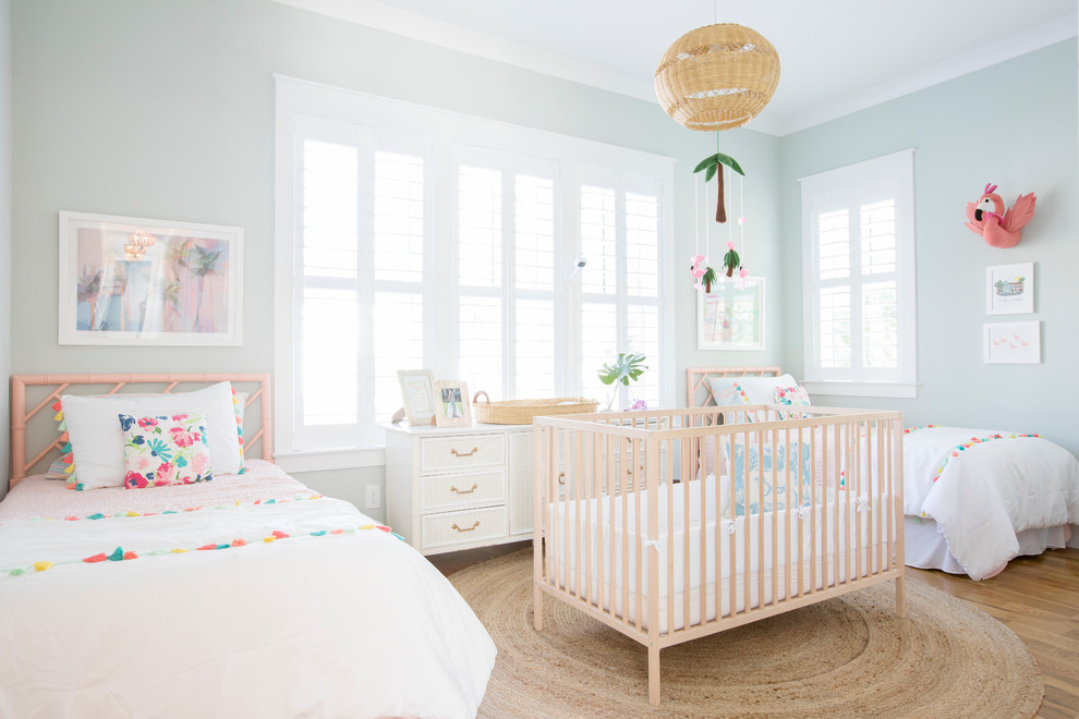 Beach style kids' bedroom in Charleston with green walls, medium hardwood flooring and brown floors.