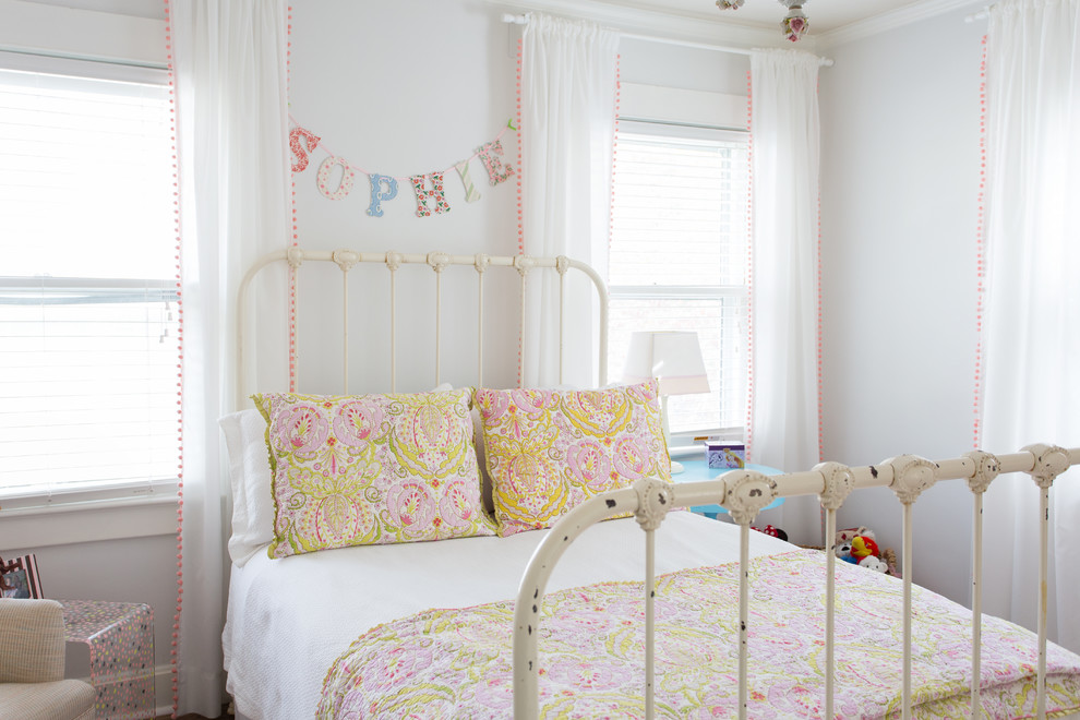 Photo of a medium sized classic children’s room for girls in Kansas City with white walls.