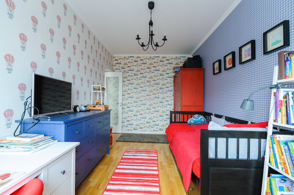 Small traditional children’s room for boys in Other with blue walls and light hardwood flooring.