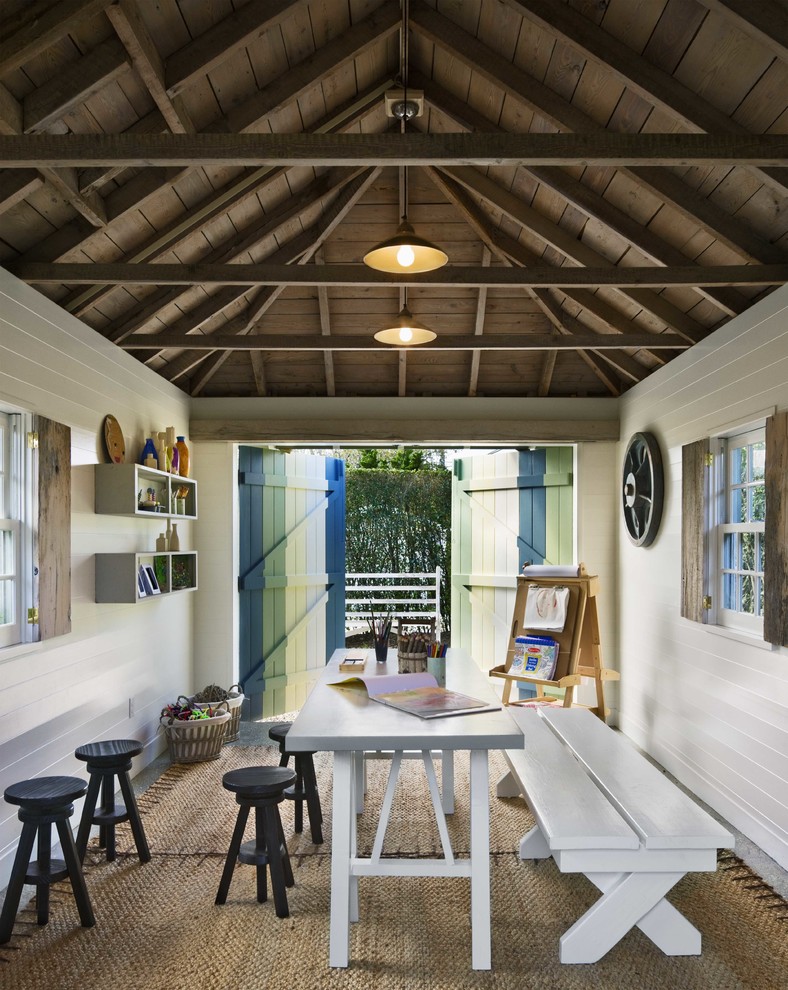 Example of a mid-sized beach style gender-neutral kids' room design in Boston with white walls