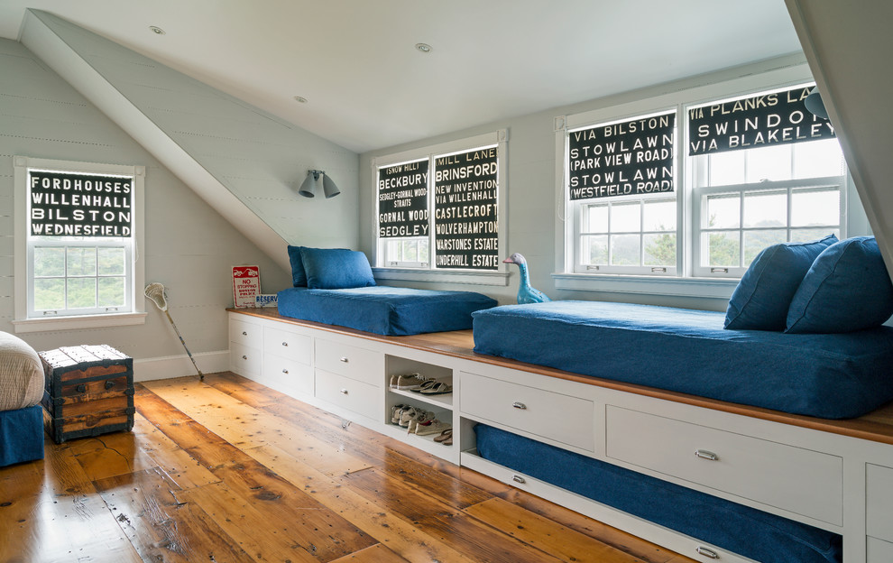 Medium sized nautical kids' bedroom for boys in New York with grey walls and medium hardwood flooring.