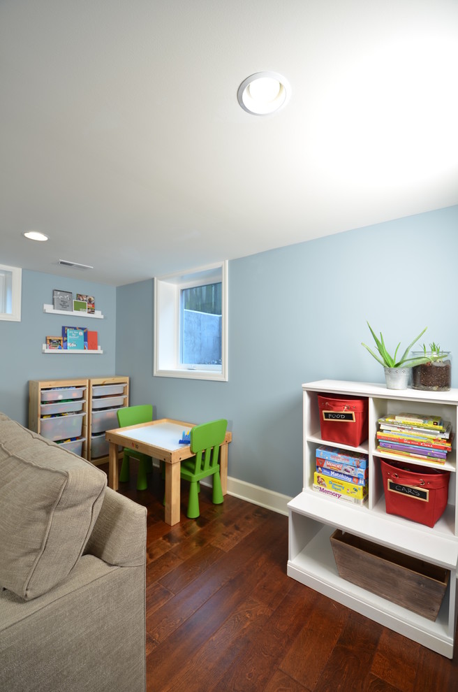 This is an example of a medium sized classic gender neutral kids' bedroom in Portland with blue walls and dark hardwood flooring.