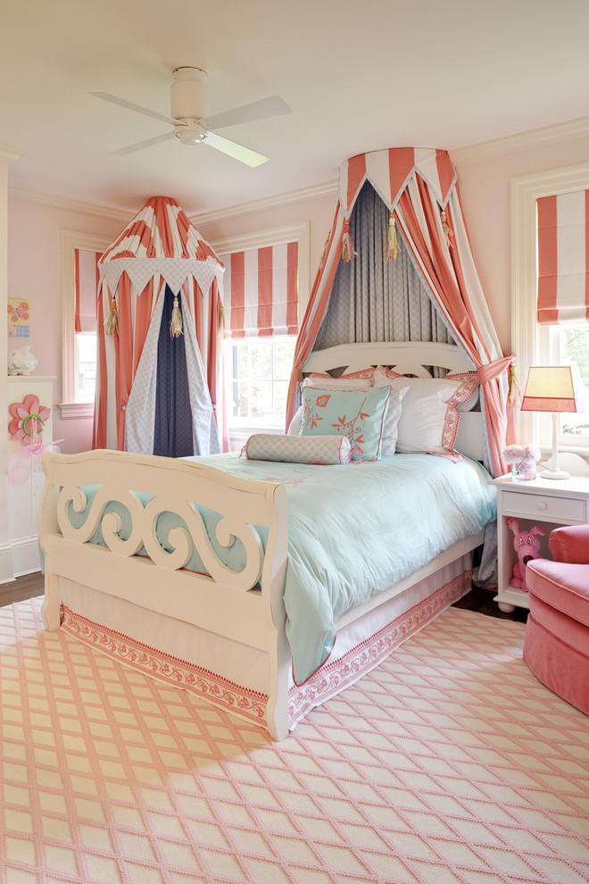 Aménagement d'une chambre d'enfant de 4 à 10 ans classique avec un mur rose et parquet foncé.