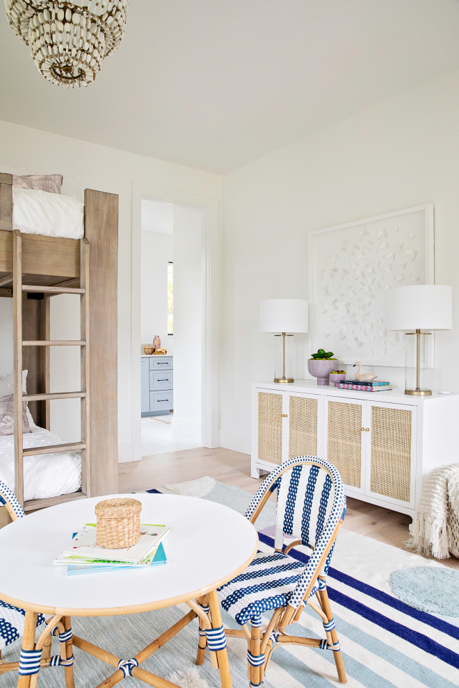 Inspiration for a large classic children’s room for girls in Orlando with white walls, light hardwood flooring and brown floors.