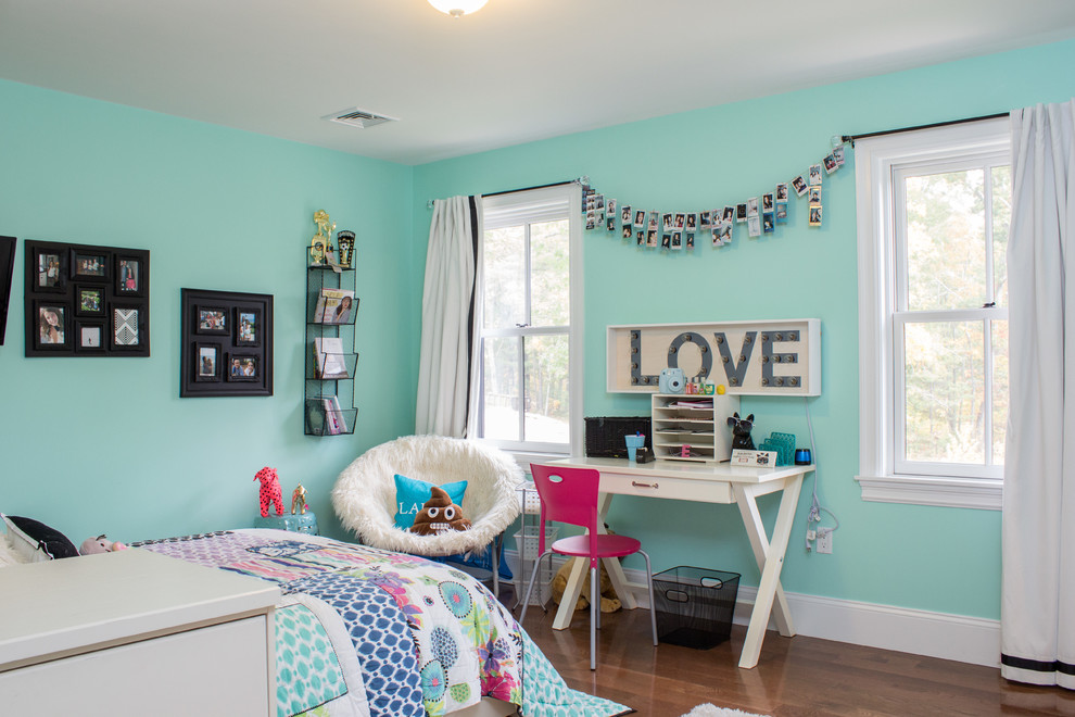 This is an example of a traditional teen’s room for girls in Boston with blue walls and dark hardwood flooring.