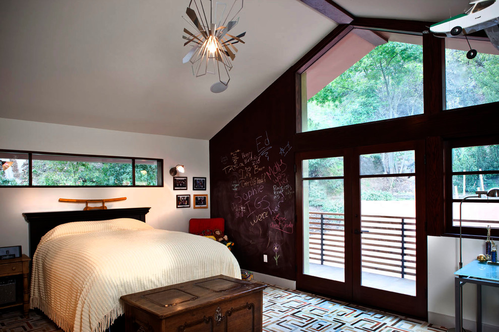 This is an example of a contemporary gender neutral teen’s room in Los Angeles with white walls and carpet.