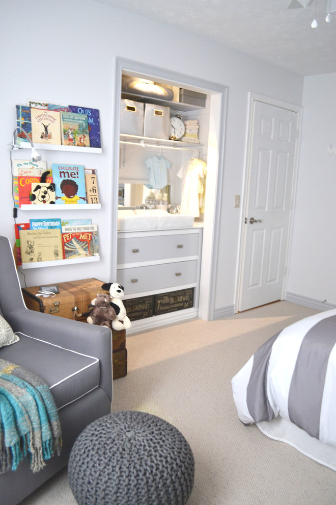 Idée de décoration pour une chambre d'enfant de 1 à 3 ans design de taille moyenne avec un mur blanc, moquette et un sol beige.