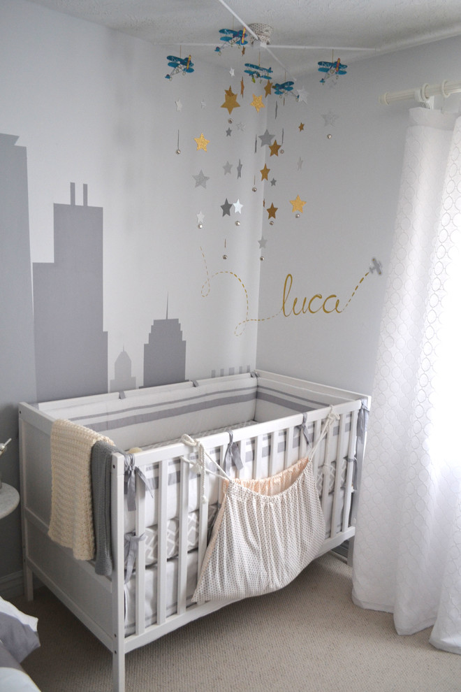 Inspiration for a mid-sized contemporary boy carpeted and beige floor nursery remodel in Omaha with gray walls