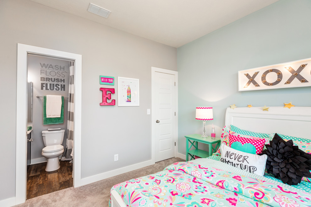 This is an example of a medium sized traditional children’s room for girls in Other with blue walls and carpet.