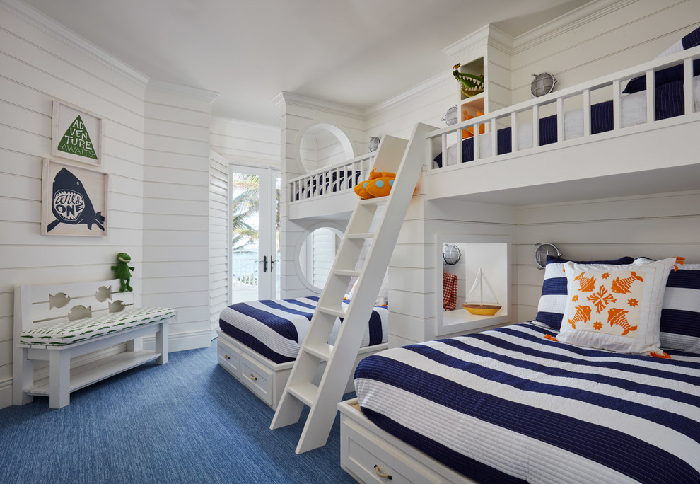 Photo of a beach style children’s room in Miami with white walls, carpet and blue floors.