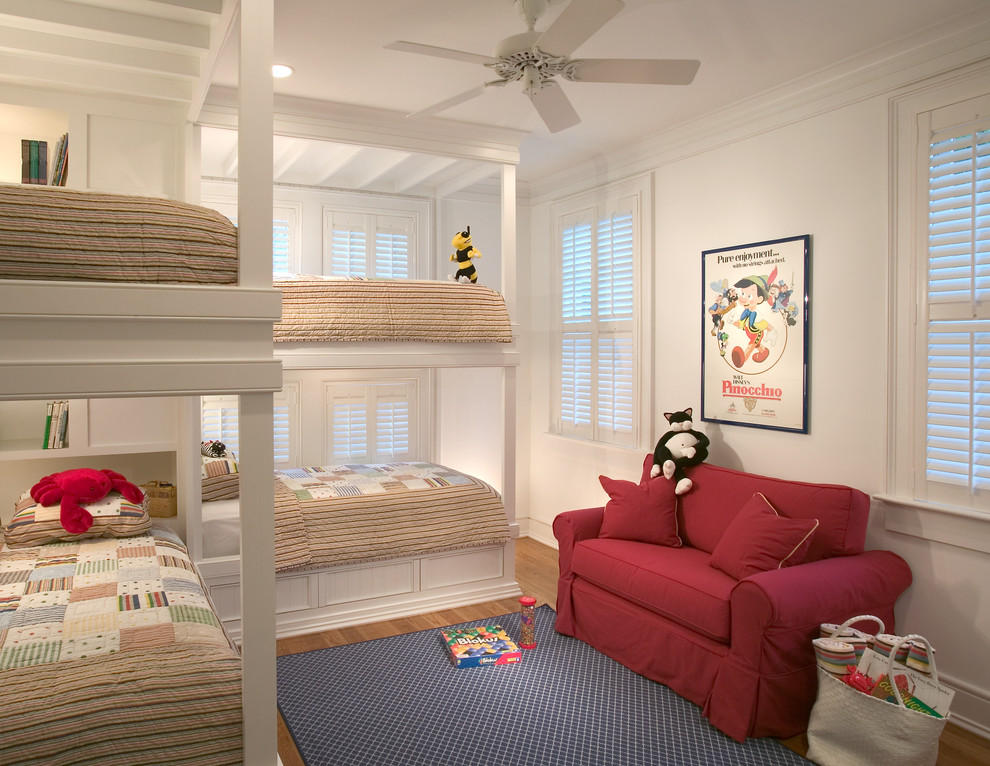 Kids' room - mid-sized coastal medium tone wood floor kids' room idea in Charleston with white walls