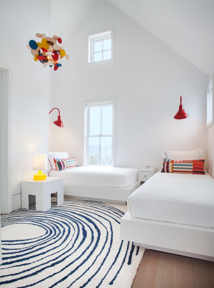 Large beach style gender-neutral medium tone wood floor kids' bedroom photo in Boston with white walls