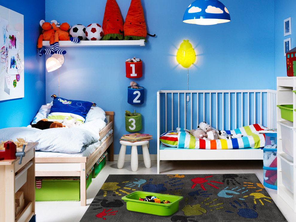 На фото: маленькая нейтральная детская в стиле фьюжн с спальным местом, синими стенами, бетонным полом и серым полом для на участке и в саду, ребенка от 1 до 3 лет