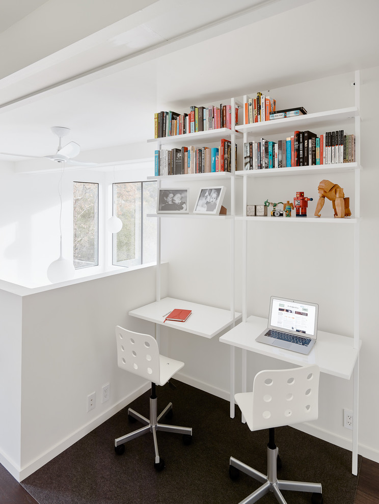 This is an example of a modern gender neutral kids' study space in San Francisco with white walls, carpet and grey floors.
