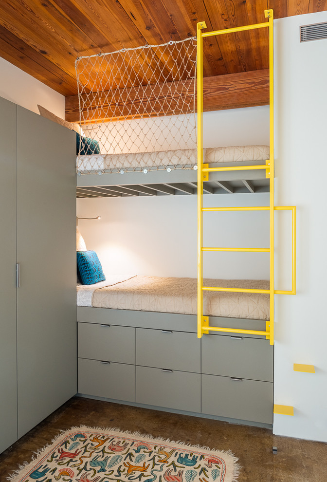 Imagen de dormitorio infantil de 4 a 10 años contemporáneo con paredes blancas, suelo de cemento y suelo marrón
