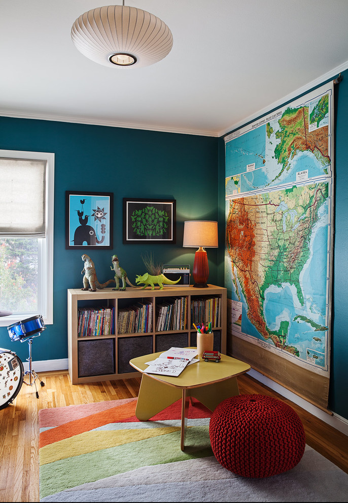 Inspiration for an eclectic boy medium tone wood floor kids' room remodel in San Francisco with blue walls