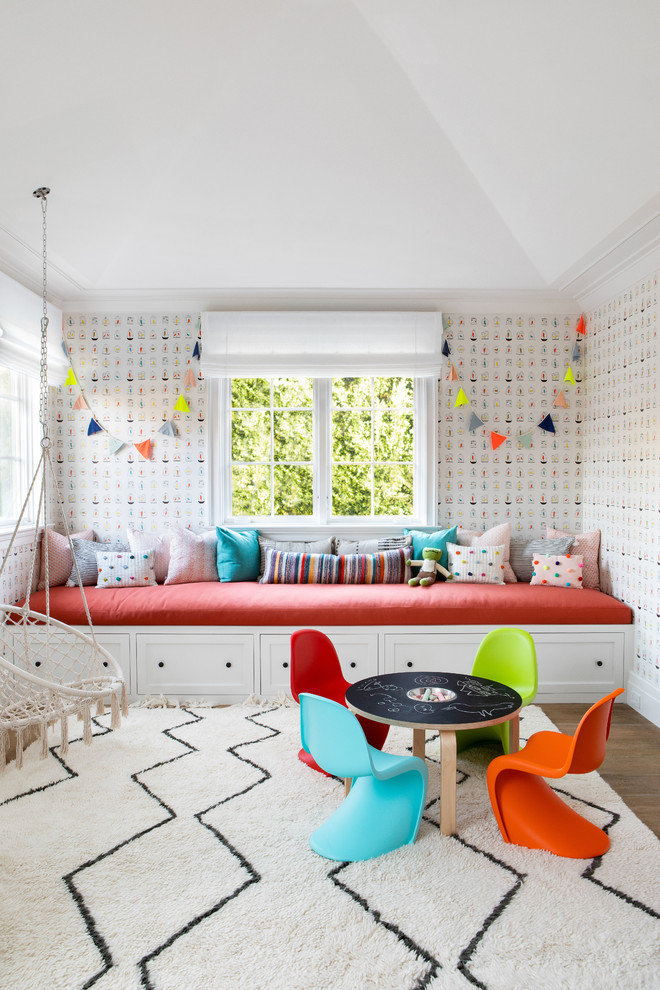 Photo of a large classic gender neutral kids' bedroom in New York with multi-coloured walls, medium hardwood flooring and brown floors.