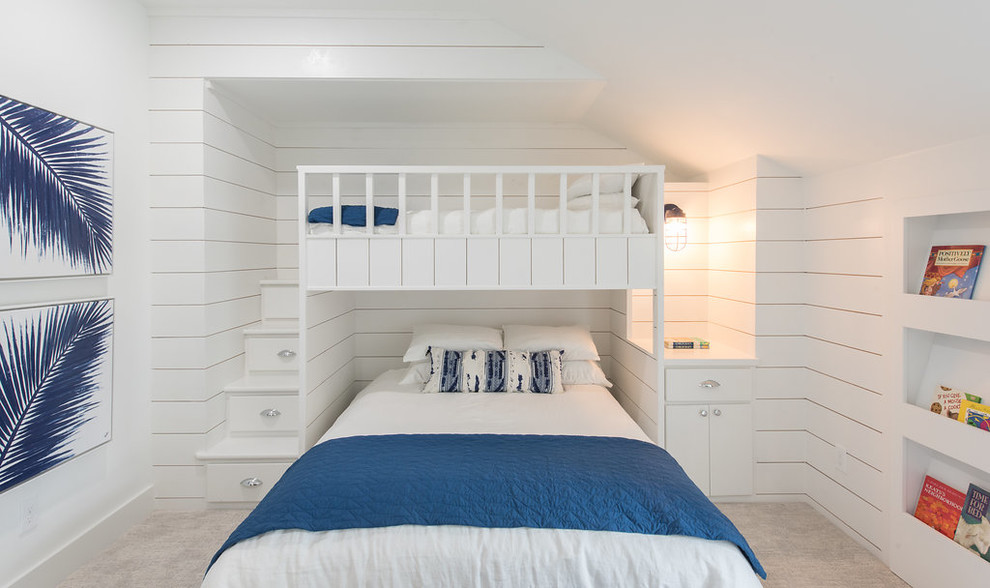 This is an example of a large beach style gender neutral children’s room in Houston with white walls, carpet and beige floors.