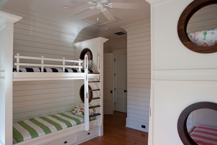 Large island style gender-neutral dark wood floor kids' room photo in Charleston with white walls