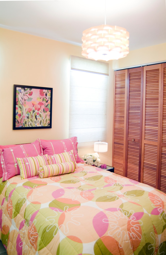 This is an example of a contemporary children’s room for girls in Other with pink walls.