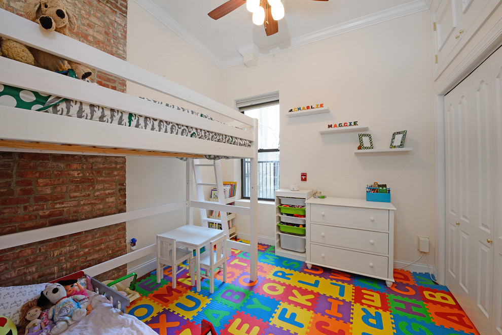 Trendy gender-neutral multicolored floor kids' bedroom photo in New York with beige walls